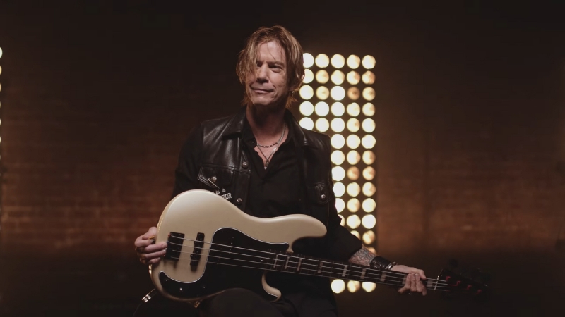 Duff McKagan holding his bass guitar during an interview