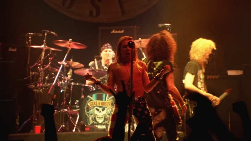 Guns N’ Roses perform live on stage during their classic lineup era, with Axl Rose front and center