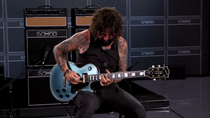 Tracii Guns plays guitar during a studio session