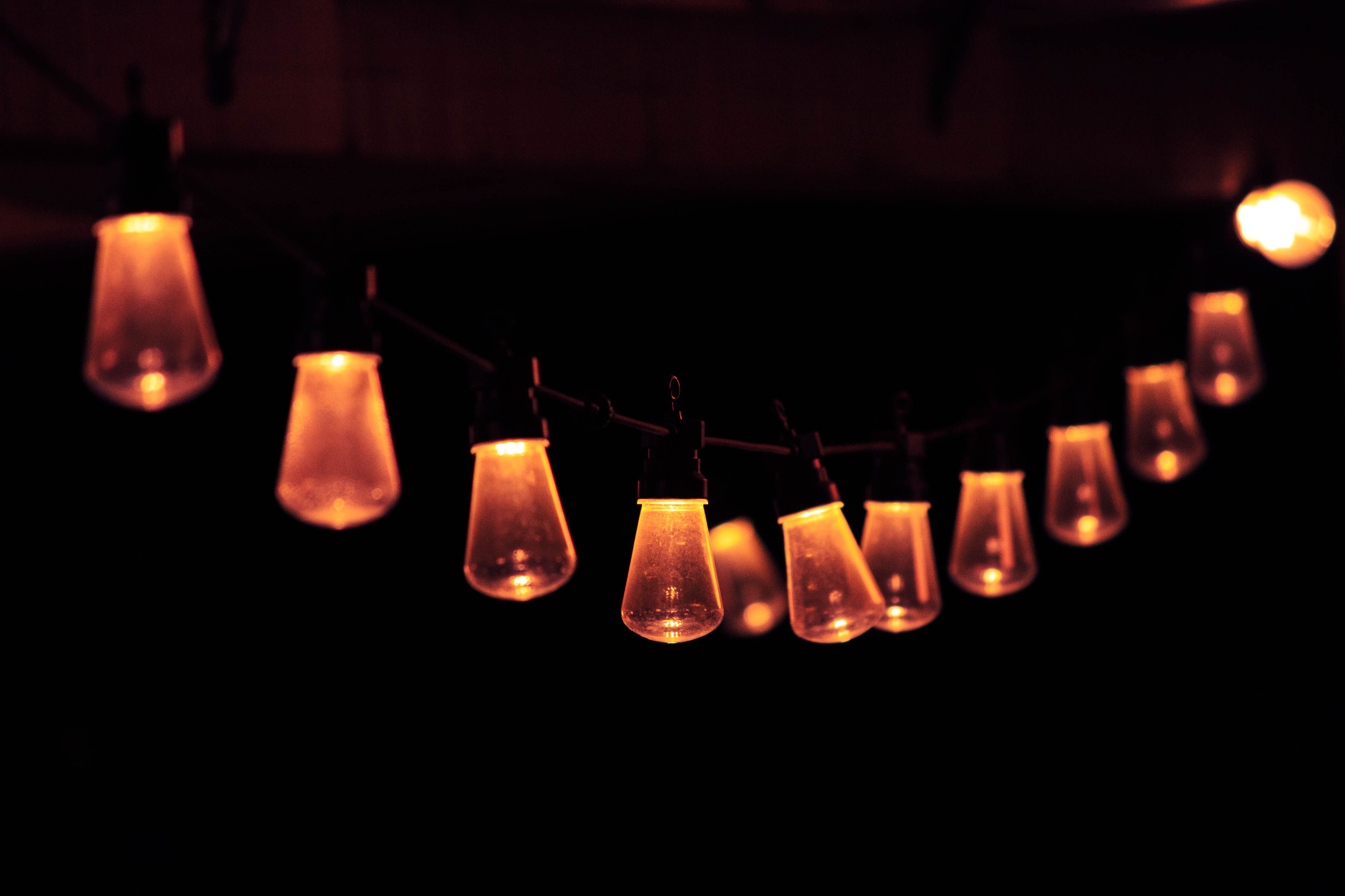 String of warm glowing lights in the dark creating a cozy outdoor atmosphere